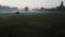 Fog and sunrise. Horse and mill in foggy morning on the field. calm sad depressive mystical atmosphere. Countryside