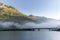 The fog surrounding the bridge on the lake of Silvaplana in the Engadin valley at sunrise