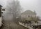 Fog and traditional stone houses in Vizitsa village on mountain
