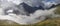 Fog in the valley and clouds on the tops. Mountain, Altai. Panoramic view