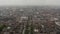 Foggy aerial view of large town. Tilt down footage to wide street and tall steel pinlike Monument of Light. Dublin