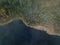 Foggy aerial view of shoreline with forest with autumn foliage