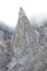 foggy alpine mountainside with rocks and clouds side by side