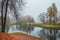 Foggy autumn landscape with first snow in State Museum Reserve Gatchina. Foggy autumn view of the park, Karpin Pond and old stone