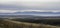 Foggy autumn landscape of mountains with valleys and river. Pano