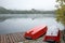 The foggy autumn Strbske Pleso lake with boats on the pier