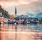 Foggy autumn sunrise on Hallstatt lake. Spectacular morning view of Hallstatt village, in Austria`s mountainous Salzkammergut