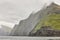 Foggy cliffs landscape and atlantic ocean. Faroe islands