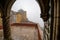 Foggy day peeking through the arches at the Pena Palace to the rest of the castle grounds