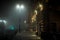 Foggy deserted street with sidewalk at night