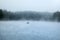 Foggy Lake With A Fisherman