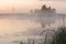 Foggy landscape of early morning before sunrise over a river