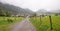 Foggy landscape Rubi, with hiking way and bench, tourist destination near Oberstdorf