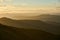 Foggy and misty layers of mountain ranges at sunrise