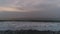 Foggy morning over the beach and flying seagulls. Dramatic sea sunrise. Waves