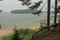 Foggy morning by the sea. Sandy coast, pine forest. the island is visible in the distance. The nature of Scandinavia. Finland. Por