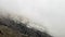 Foggy mountain landscape. Majestic mountains, cliffs and a glacier.