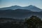 foggy mysterious bluish mountains in the distance. Layers of mountains in Sardinia in Italy at the sunset.