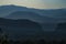 foggy mysterious bluish mountains in the distance. Layers of mountains in Sardinia in Italy at the sunset.