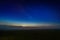 Foggy night field with starry night sky and afterglow horizon gradient