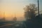 foggy road at sunset with power lines and telephone poles