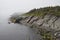 Foggy rugged shoreline landscape along the Killick coast