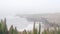 Foggy sea landscape, waves crashing on ocean beach in haze, calm misty weather.