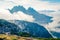 Foggy summer view of Gruppo Del Cristallo mountain range in Tre Cime Di Lavaredo national park. Sunny morning scene of Dolomite