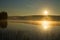 Foggy sunrise on the forest lake. August morning. Finland