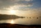 Foggy sunrise landscape photo with boat, mountain in the morning