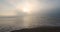 Foggy sunrise over ocean coast. Sea sunrise on the beach, 4k video
