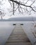 A foggy vertical winter view of the boat pier at Rockland Lake State Park in Rockland