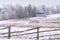 Foggy winter rural scene with barn, fence and a bridge. Rime ice covers the trees. Taken in Scandia, Minnesota