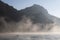 Fogs and mists at sunrise and canoeist in the bay of Pasaia, Euskadi