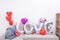 Foil love balloons and gifts on a sofa with white wall in background for Valentine`s day, Mother`s day surprise design concept