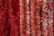 Foil red silver tinsel with fluffy polyethylene needles, background backdrop. Stripes shiny scarlet garland made of polythene foil