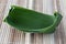 Fold the banana leaf to make a container for food. Help reduce plastic waste.