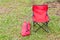 Foldable camping chair with the green lawn background.