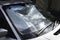 Foldable reflective sunshade on the inside of a car windshield