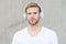 Foldable Stereo Headphones. Noise Reduction. Wireless Earpiece. Handsome guy wear headphones grey background. Man listen