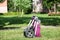 Folded baby pushchair is on green meadow in summer sunny park, an infant perambulator series