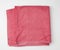 Folded bath terry pink towel on a white background