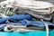 Folded bedding, jeans, towels on a blue box. Pile of laundry and clothes prepared for washing. Closeup view