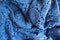 Folded blue lacy cotton fabric