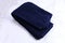 Folded blue navy towel on marble background