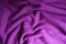 Folded bright violet woolen knitted fabric