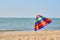 Folded colored beach umbrella on the beach. Closing of the holiday season