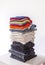 Folded colorful clothes in stack. Home organizing. Domestic storage