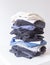 Folded colorful clothes in stack. Home organizing. Domestic storage