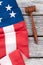 Folded flag of USA and wooden gavel.